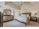 Spacious main bedroom boasts tray ceilings, neutral tones, and stylish furniture at 1130 Laurel Cove Dr, Snellville, GA 30078