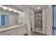 Bright bathroom features dual sinks, granite countertops, vinyl floors, and a glass shower at 18 Loth Wages (Lot 18) Rd, Dacula, GA 30019