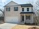 Charming two-story home with a brick facade and a two-car garage at 18 Loth Wages (Lot 18) Rd, Dacula, GA 30019