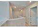 Second floor hallway with carpeted floor, neutral paint and white trim at 18 Loth Wages (Lot 18) Rd, Dacula, GA 30019