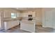 Well-lit kitchen featuring white cabinets, stainless steel appliances, granite countertops and a central island at 18 Loth Wages (Lot 18) Rd, Dacula, GA 30019