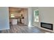 Open concept living room with fireplace and access to kitchen at 18 Loth Wages (Lot 18) Rd, Dacula, GA 30019