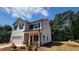 Charming two-story home with white siding, black shutters, and a two-car garage at 2 Loth Wages (Lot 2) Rd, Dacula, GA 30019