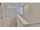 Upstairs hallway with a neutral color palette and lots of natural light at 2 Loth Wages (Lot 2) Rd, Dacula, GA 30019