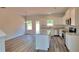Modern kitchen with white cabinets, granite countertops, stainless steel appliances, and a center island at 2 Loth Wages (Lot 2) Rd, Dacula, GA 30019