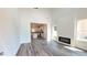 Bright living room featuring high ceilings, wood floors, and a modern fireplace open to the kitchen at 2 Loth Wages (Lot 2) Rd, Dacula, GA 30019