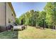 Beautiful backyard with mature trees, bench seating and ambient lighting at 345 Piedmont Cir, Covington, GA 30016