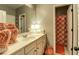 Bright bathroom with vanity, floral shower curtain, and decorative vases and lamps at 345 Piedmont Cir, Covington, GA 30016