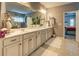 Bright bathroom featuring double sinks, cabinets, and a decorative mirror at 345 Piedmont Cir, Covington, GA 30016