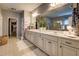 Bright bathroom with a double sink vanity, large mirror, and walk-in closet at 345 Piedmont Cir, Covington, GA 30016
