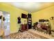 Bright yellow bedroom with vintage furniture, work space, and unique decor at 345 Piedmont Cir, Covington, GA 30016