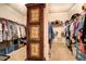 Spacious walk-in closet with custom storage solutions and an antique wardrobe at 345 Piedmont Cir, Covington, GA 30016