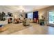 Open-concept living room with tile and carpet, natural light, and access to the outdoor area at 345 Piedmont Cir, Covington, GA 30016