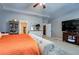 Well-lit main bedroom with carpet flooring, tv and ample closet and storage space at 345 Piedmont Cir, Covington, GA 30016