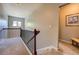 Upstairs hallway with staircase access to upper level and carpeted floor at 345 Piedmont Cir, Covington, GA 30016