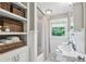 Bright bathroom featuring built-in storage shelves and a window overlooking a lush green view at 901 United Se Ave, Atlanta, GA 30316