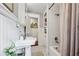 Compact bathroom design with tiled floors, shower/tub combo, and a pedestal sink at 901 United Se Ave, Atlanta, GA 30316