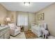 Adorable Bedroom with crib, glider, soft textures, and warm lighting creating a serene space at 901 United Se Ave, Atlanta, GA 30316