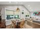 Charming dining area featuring a round wooden table, wicker chairs, and natural light from large windows at 901 United Se Ave, Atlanta, GA 30316