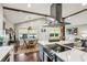 Bright kitchen with an island, stainless steel appliances, quartz countertops and exposed beams at 901 United Se Ave, Atlanta, GA 30316