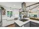 Bright and airy kitchen with white cabinetry and a center island cooktop at 901 United Se Ave, Atlanta, GA 30316