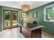 Stylish home office with green walls, a large wooden desk, and views to the backyard at 901 United Se Ave, Atlanta, GA 30316