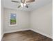 Bedroom featuring hardwood floors, a ceiling fan and a window with a view of the greenery outside at 1939 Dunlap Ave, Atlanta, GA 30344
