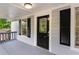 Inviting covered front porch with gray flooring, a decorative door, and gray painted siding at 1939 Dunlap Ave, Atlanta, GA 30344