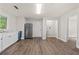 Bright kitchen with new hardwood floors, stainless steel refrigerator, white cabinets and countertops at 1939 Dunlap Ave, Atlanta, GA 30344