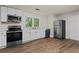 Modern kitchen with white cabinets, stainless steel appliances, and wood-look flooring at 1939 Dunlap Ave, Atlanta, GA 30344