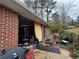 View of the carport, with the exterior brick and some of the backyard at 2234 Glendale Dr, Decatur, GA 30032