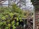 Exterior shot showing side of the house with overgrown bushes and debris at 2234 Glendale Dr, Decatur, GA 30032