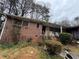 Charming brick home with a cozy front porch, surrounded by lush greenery at 2234 Glendale Dr, Decatur, GA 30032