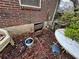 Exterior shot showing the foundation, brick siding, and a basement entrance at 2234 Glendale Dr, Decatur, GA 30032