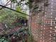 Exterior shot showing the brick foundation, drain pipe, and chain link fence at 2234 Glendale Dr, Decatur, GA 30032