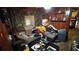 Untidy living room featuring a brown sofa, wood paneling, and cluttered surfaces at 2234 Glendale Dr, Decatur, GA 30032