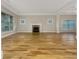 Bright living room with a fireplace, large windows, light walls, crown moulding, and gleaming hardwood floors at 2419 Boulder Se Rd, Atlanta, GA 30316
