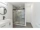 Bright bathroom featuring marble shower, floating vanity, and round mirror at 4011 Redan Rd # 7, Stone Mountain, GA 30083