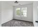 Bright bedroom featuring two windows, neutral carpet, and modern lighting fixture at 4011 Redan Rd # 7, Stone Mountain, GA 30083