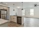 Open kitchen with stainless steel appliances, island with sink and pendant lighting at 4011 Redan Rd # 7, Stone Mountain, GA 30083