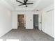 Spacious main bedroom featuring a tray ceiling, ceiling fan, carpet flooring and adjacent bath at 4011 Redan Rd # 7, Stone Mountain, GA 30083