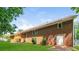 View of the backyard with lush green lawn and a brick home featuring a wooden deck at 263 Austin Rd, Stockbridge, GA 30281