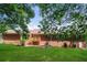 View of the backyard with lush green lawn and a brick home featuring a wooden deck at 263 Austin Rd, Stockbridge, GA 30281