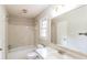 Well-lit bathroom with a tub, toilet, window, vanity, mirror, and bright neutral tones at 263 Austin Rd, Stockbridge, GA 30281