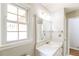 Bathroom featuring a single sink vanity, large mirror, and window that provides natural light at 263 Austin Rd, Stockbridge, GA 30281