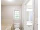 Bathroom featuring a tub, toilet, vanity, and a window providing natural light at 263 Austin Rd, Stockbridge, GA 30281