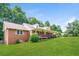 Side view of single-story brick house with covered front porch and large yard at 263 Austin Rd, Stockbridge, GA 30281