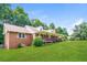Brick home featuring a cozy front porch and well-maintained lawn at 263 Austin Rd, Stockbridge, GA 30281