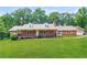 Charming single-story home with a brick facade, covered front porch, and well-manicured lawn at 263 Austin Rd, Stockbridge, GA 30281