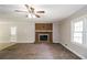 Spacious living room featuring brick fireplace and ceiling fan at 263 Austin Rd, Stockbridge, GA 30281